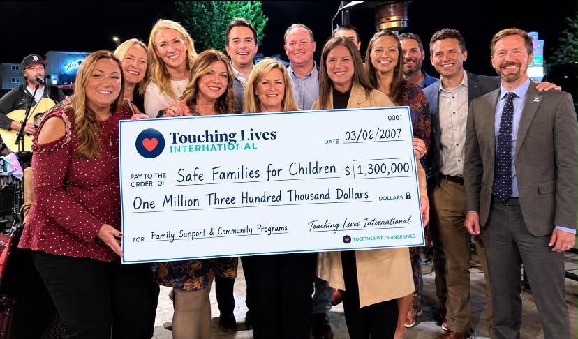 Group posing with a presentation cheque