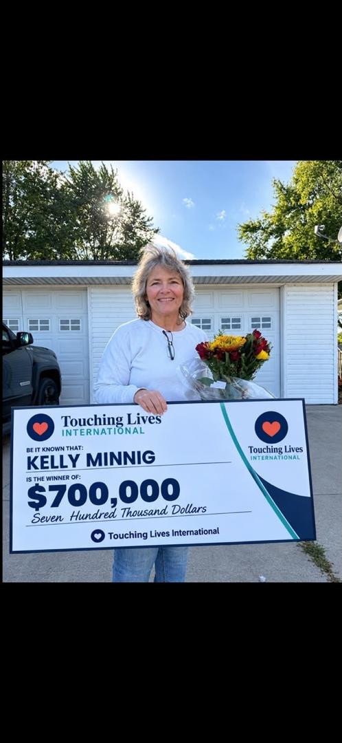 Person holding a cheque outdoors
