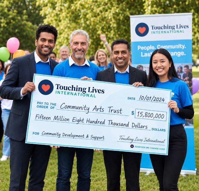 Group standing together with a presentation cheque