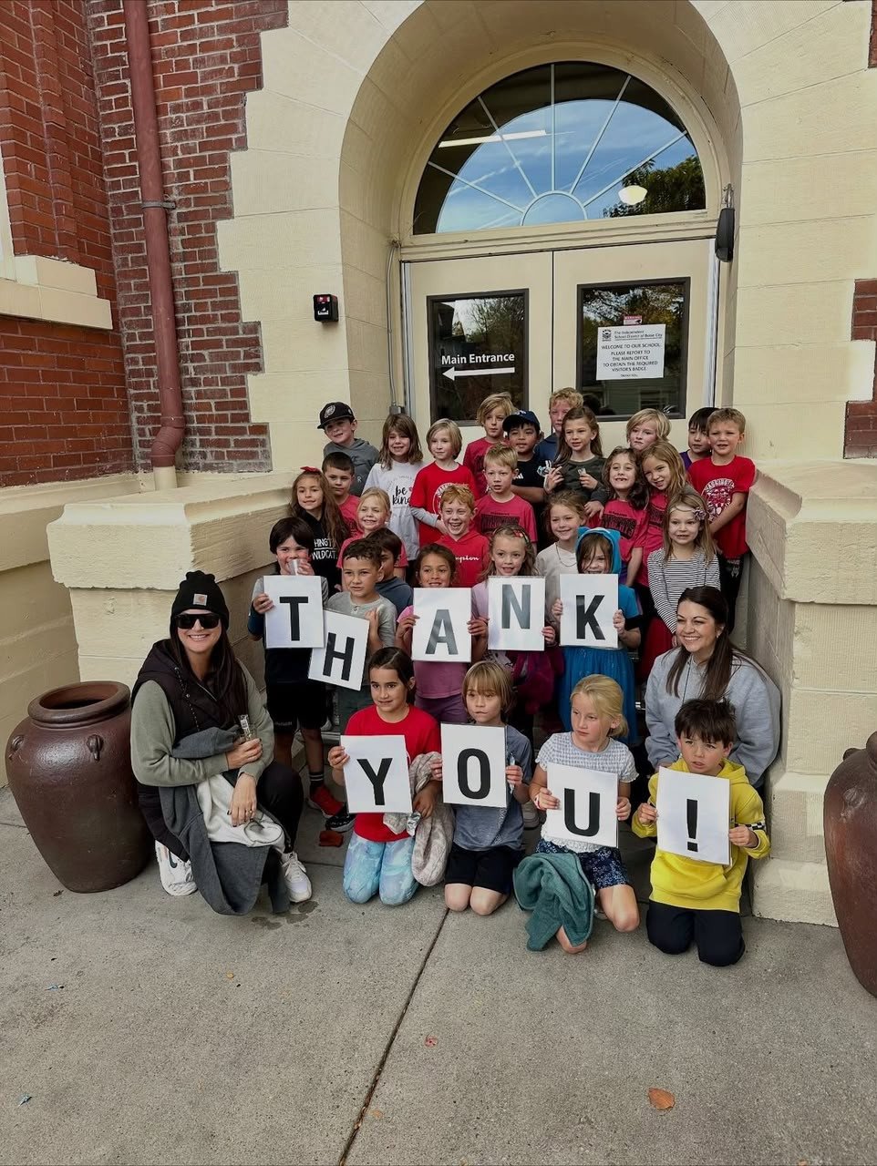 Children holding a thank-you sign